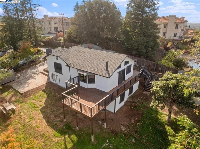 a aerial view of a house with roof deck front of house