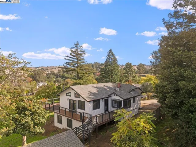 a aerial view of a house with a big yard plants and large trees