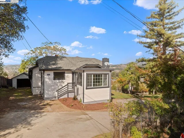 a front view of a house with a garden and yard