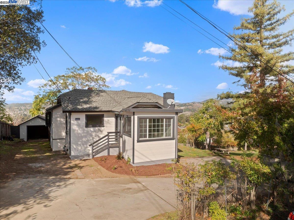 3280 Ohlone Way Hayward, CA 94541 - Photo 6 of 48 a front view of a house with a garden and yard