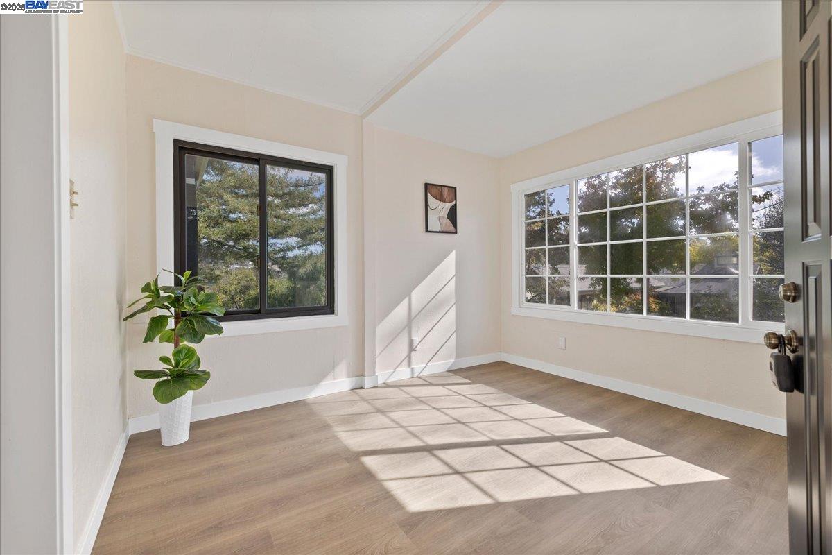3280 Ohlone Way Hayward, CA 94541 - Photo 9 of 48 a view of an empty room with wooden floor and a window
