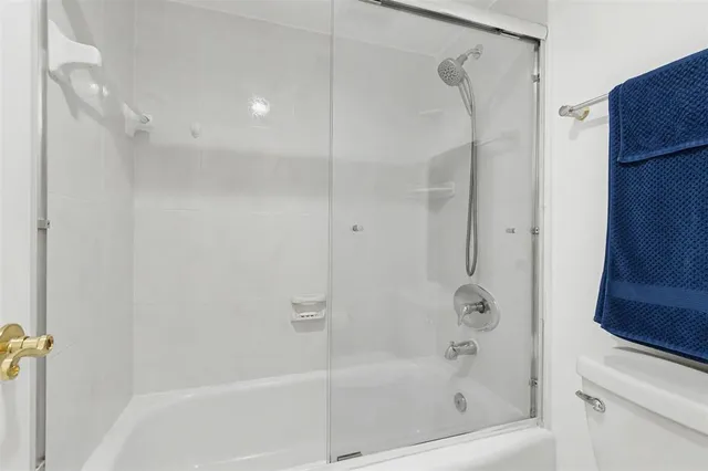 a bathroom with a shower and a bath tub