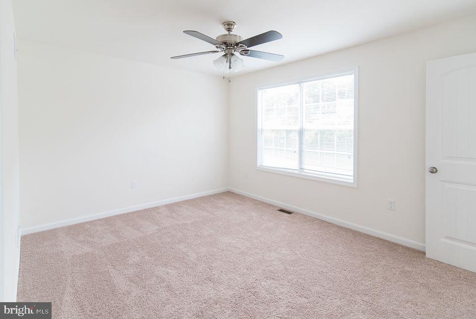 112 Breezewood Drive Hanover, PA 17331 - Photo 11 of 12 an empty room with a window and a ceiling fan