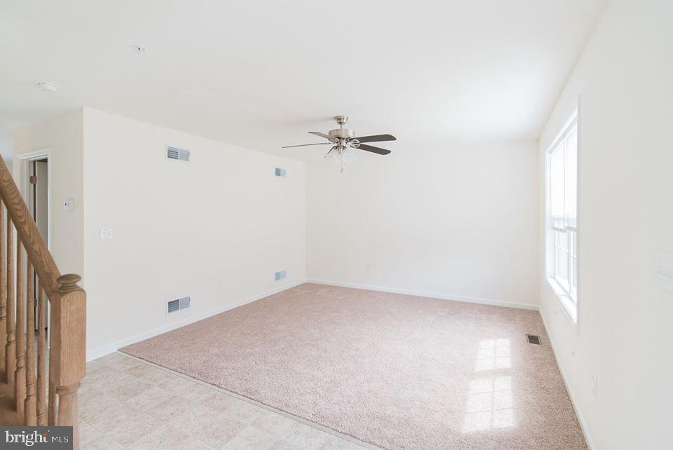 112 Breezewood Drive Hanover, PA 17331 - Photo 12 of 12 an empty room with a ceiling fan and a window