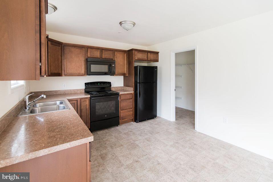 112 Breezewood Drive Hanover, PA 17331 - Photo 4 of 12 a kitchen with a refrigerator a stove top oven a sink and dishwasher
