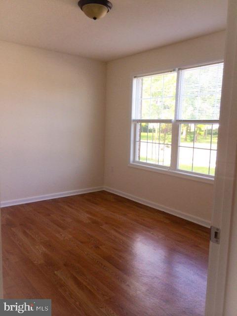 112 Breezewood Drive Hanover, PA 17331 - Photo 9 of 12 an empty room with wooden floor and windows