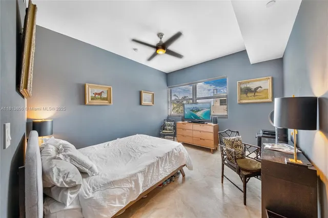 a bedroom with a bed and a desk