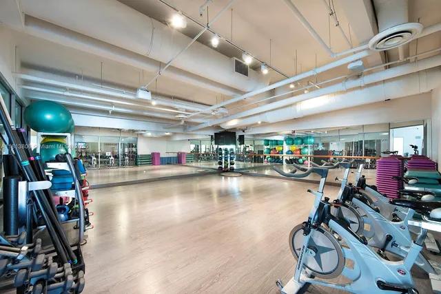 a gym room with lots of gym equipment