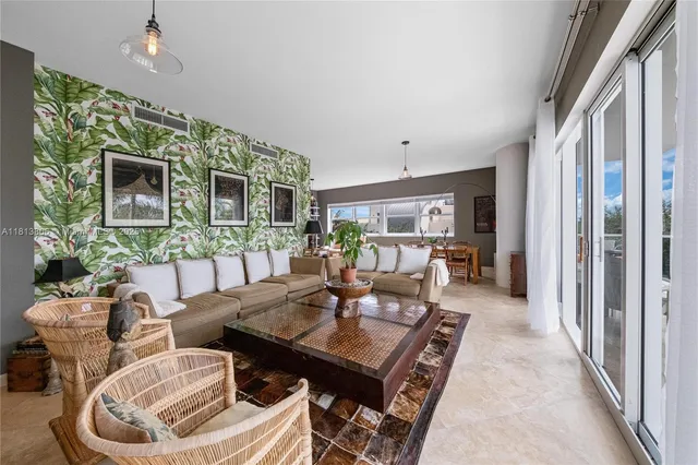 a living room with furniture a flat screen tv and a table