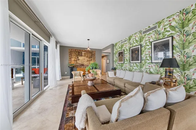 a living room with furniture fireplace and a large window