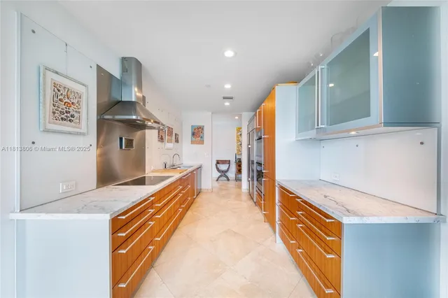 a kitchen with stainless steel appliances granite countertop a stove and a refrigerator