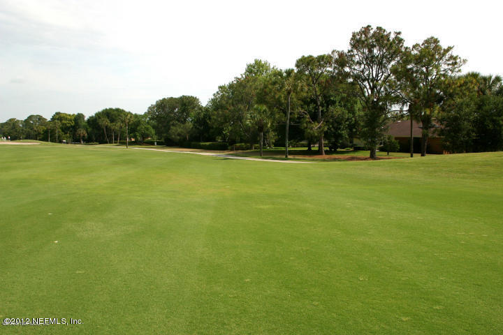 322 Pablo Road Ponte Vedra Beach, FL 32082 - Photo 19 of 19 a view of a green field with trees in the background
