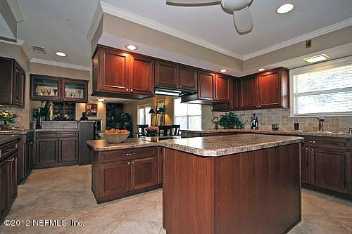 322 Pablo Road Ponte Vedra Beach, FL 32082 - Photo 7 of 19 a kitchen with stainless steel appliances granite countertop a sink a stove and a refrigerator