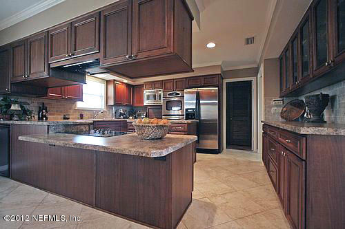 322 Pablo Road Ponte Vedra Beach, FL 32082 - Photo 8 of 19 a kitchen with stainless steel appliances granite countertop a sink a stove and a refrigerator