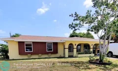 939 Burn Drive Northeast Palm Bay, FL 32905 - Photo 1 of 15 a view of a yard in front of a house