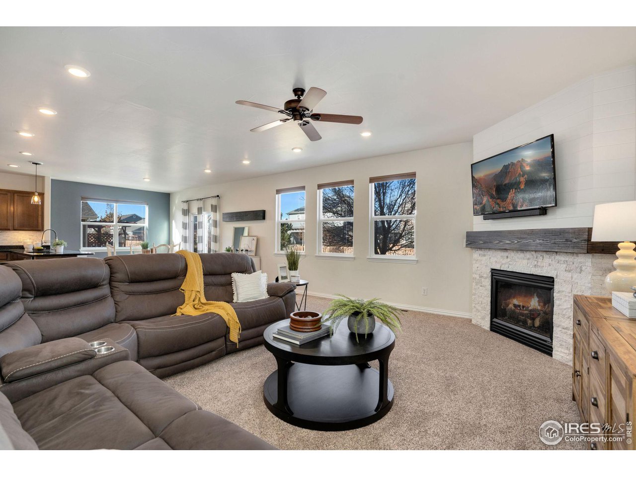 1540 Millfleet Drive Windsor, CO 80550 - Photo 11 of 40 a living room with furniture and a fireplace