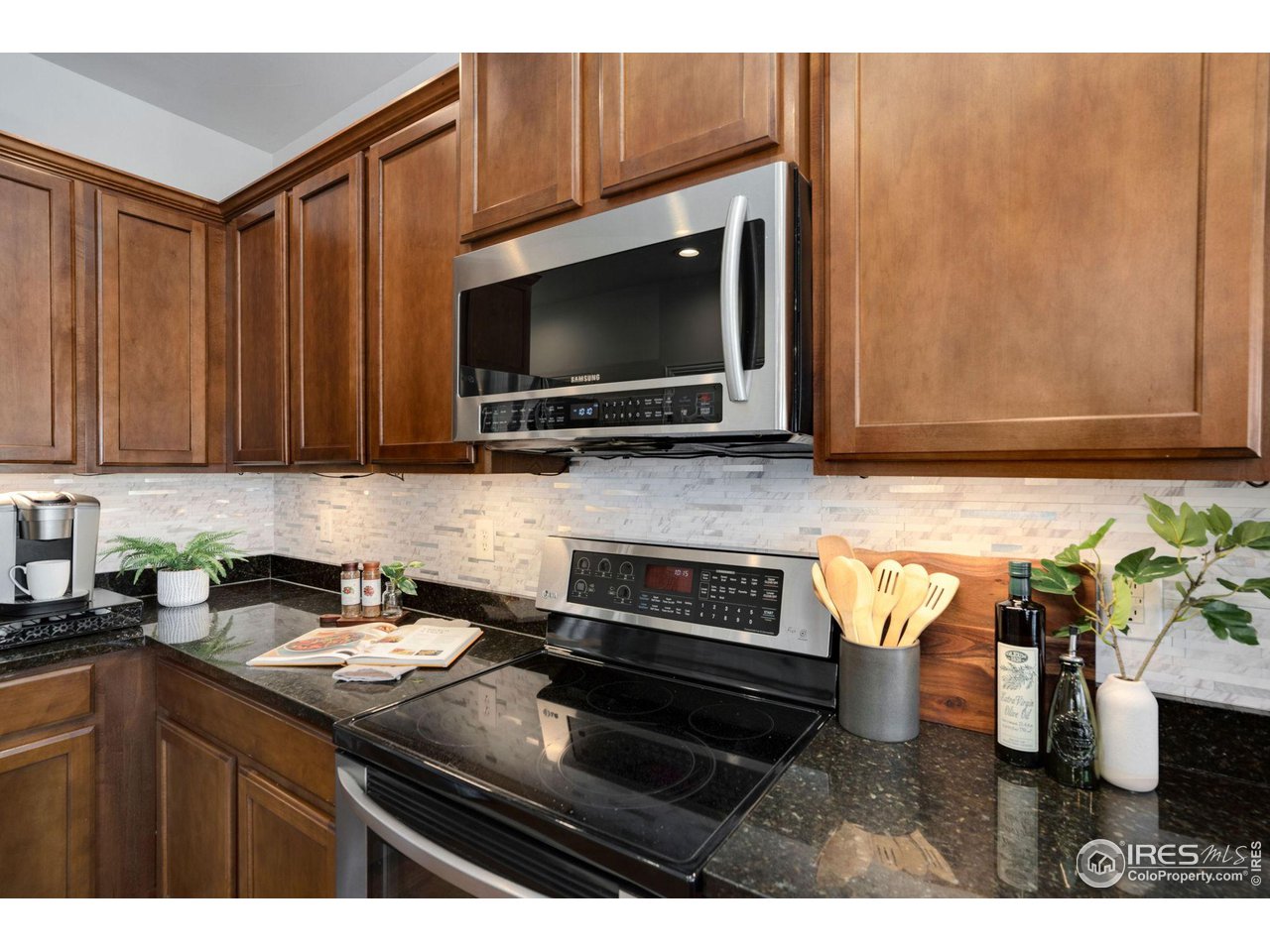 1540 Millfleet Drive Windsor, CO 80550 - Photo 15 of 40 a kitchen with a sink stove and microwave