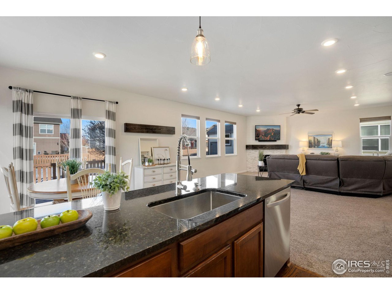 1540 Millfleet Drive Windsor, CO 80550 - Photo 16 of 40 a kitchen with stainless steel appliances granite countertop a sink and a counter top space