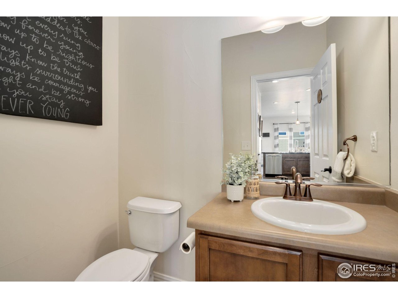 1540 Millfleet Drive Windsor, CO 80550 - Photo 18 of 40 a bathroom with a sink toilet and mirror