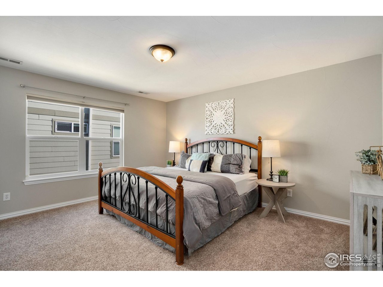 1540 Millfleet Drive Windsor, CO 80550 - Photo 24 of 40 a bedroom with a bed and a window