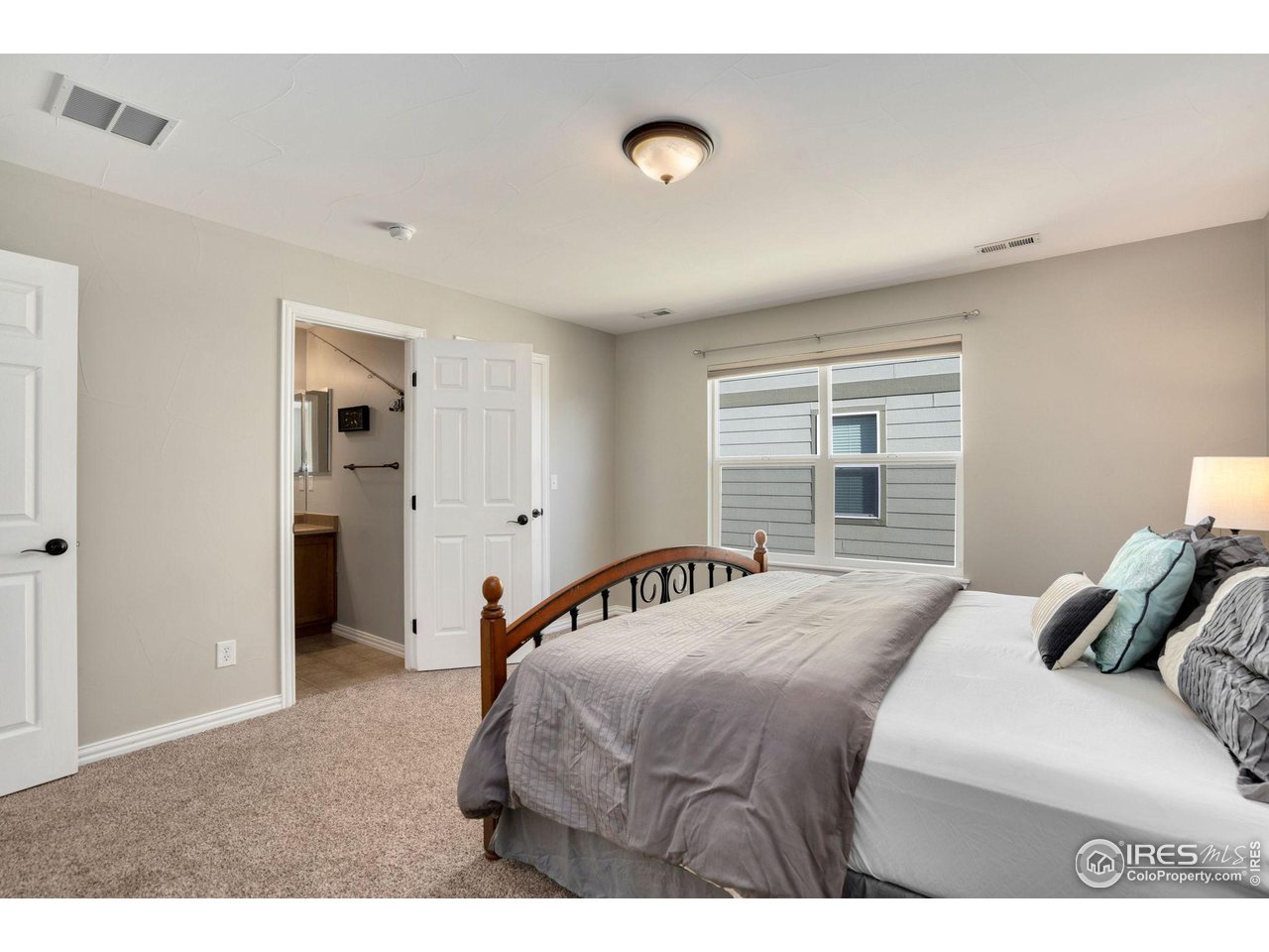 1540 Millfleet Drive Windsor, CO 80550 - Photo 25 of 40 a bedroom with a bed and a window