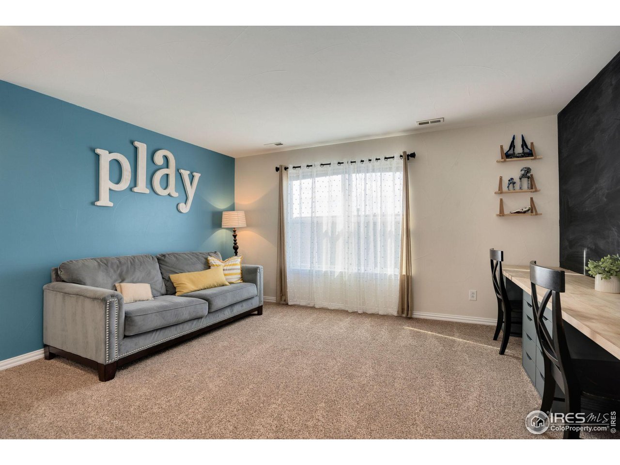 1540 Millfleet Drive Windsor, CO 80550 - Photo 28 of 40 a living room with furniture and a flat screen tv