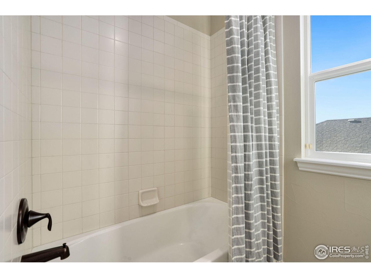 1540 Millfleet Drive Windsor, CO 80550 - Photo 33 of 40 a bathroom with a bathtub and a shower