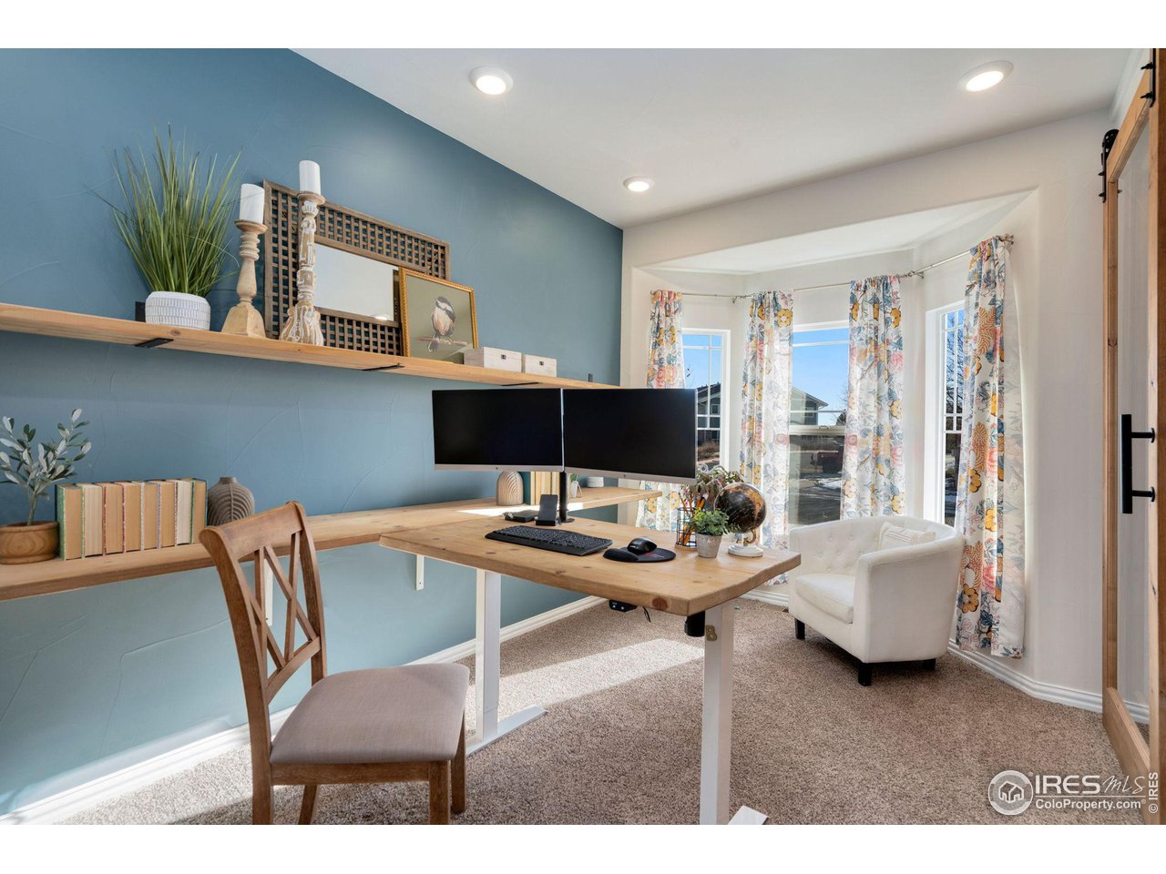 1540 Millfleet Drive Windsor, CO 80550 - Photo 6 of 40 a view of a livingroom with furniture and a potted plant