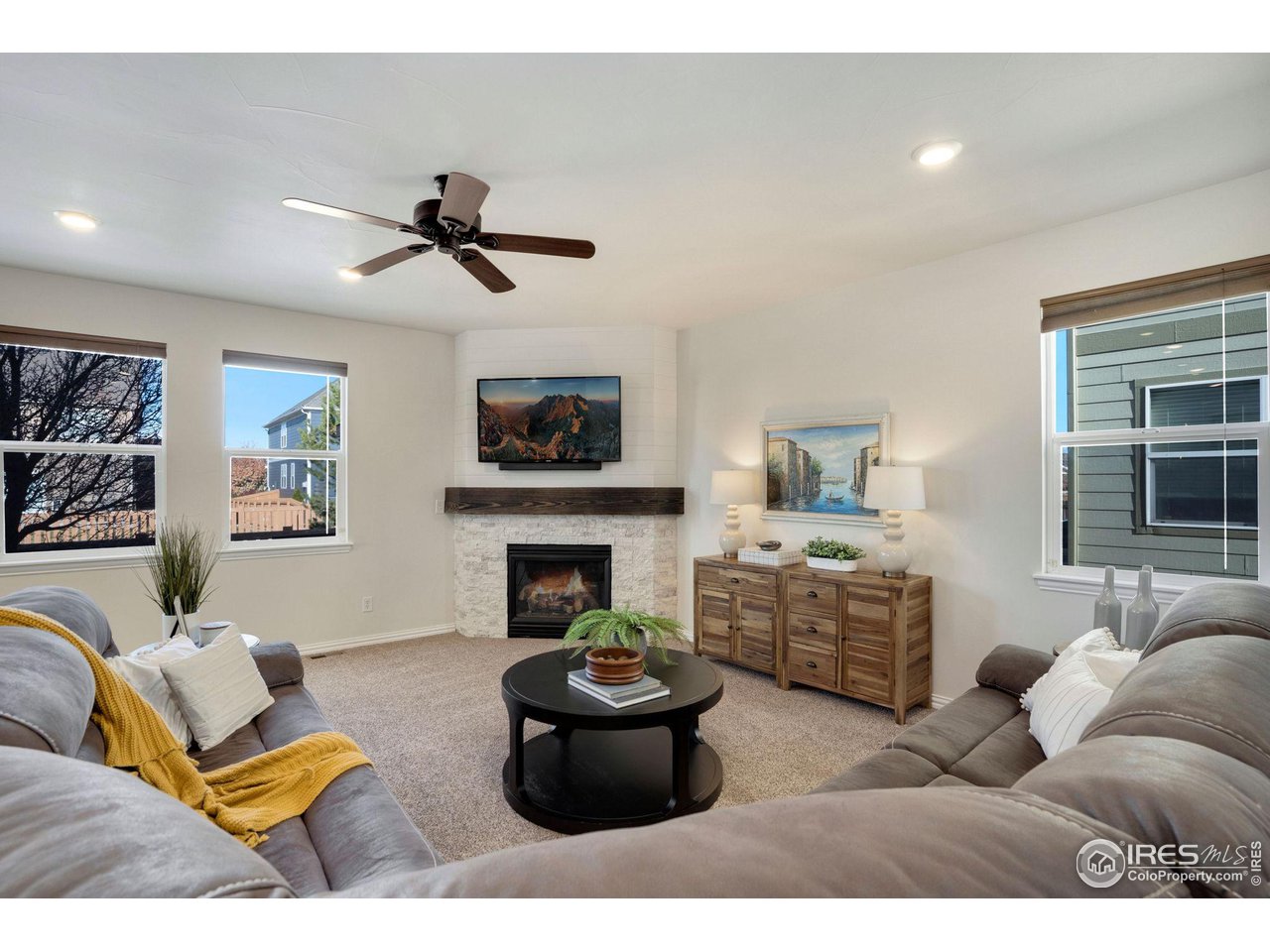 1540 Millfleet Drive Windsor, CO 80550 - Photo 9 of 40 a living room with furniture and a fireplace