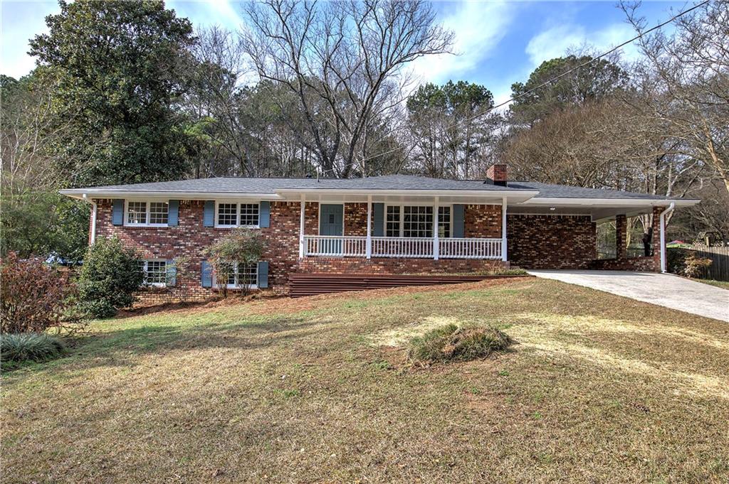 a view of a house with backyard and sitting area