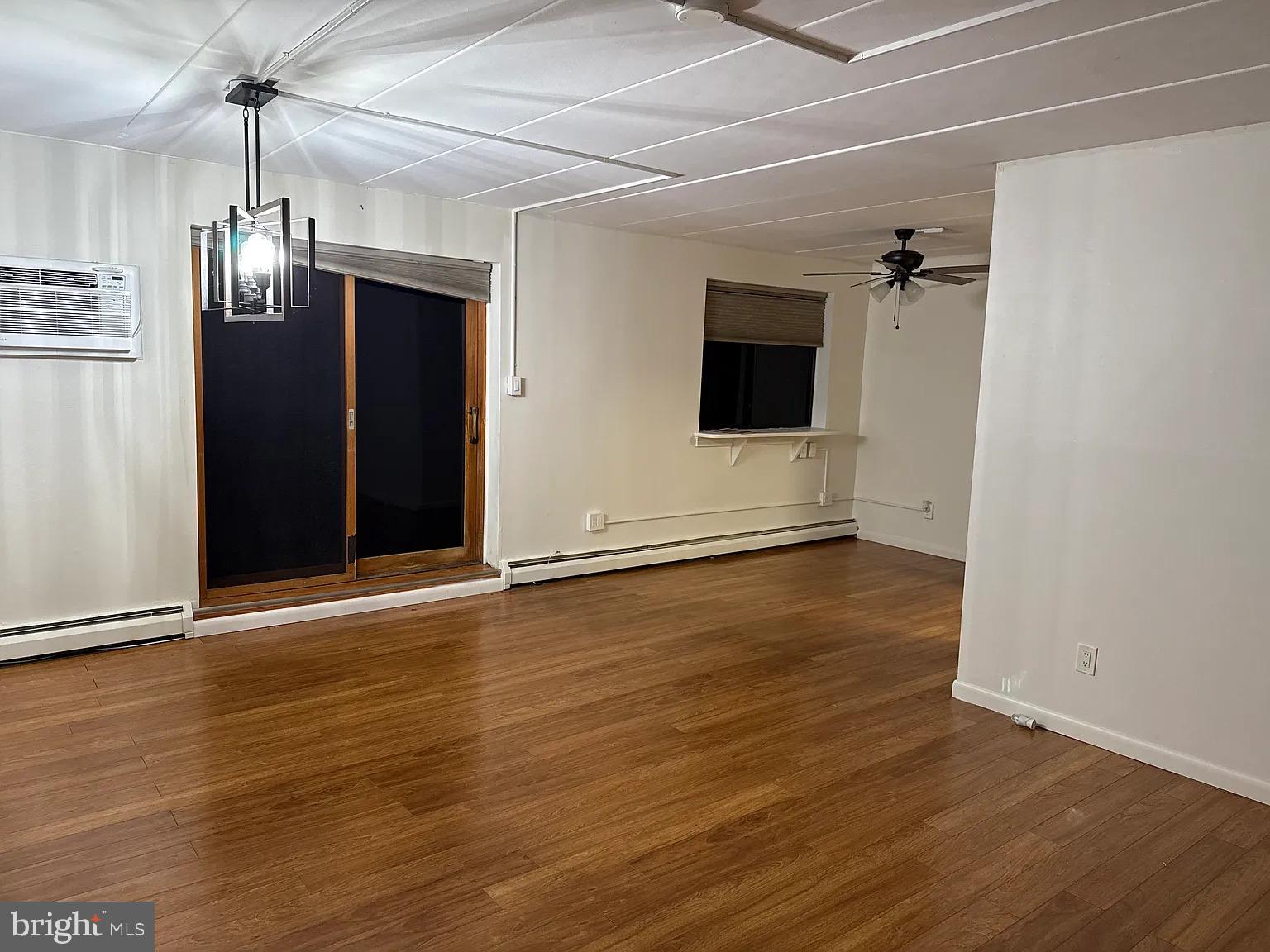1575 West Street Road, Unit 812 Warminster, PA 18974 - Photo 5 of 17 an empty room with wooden floor and windows