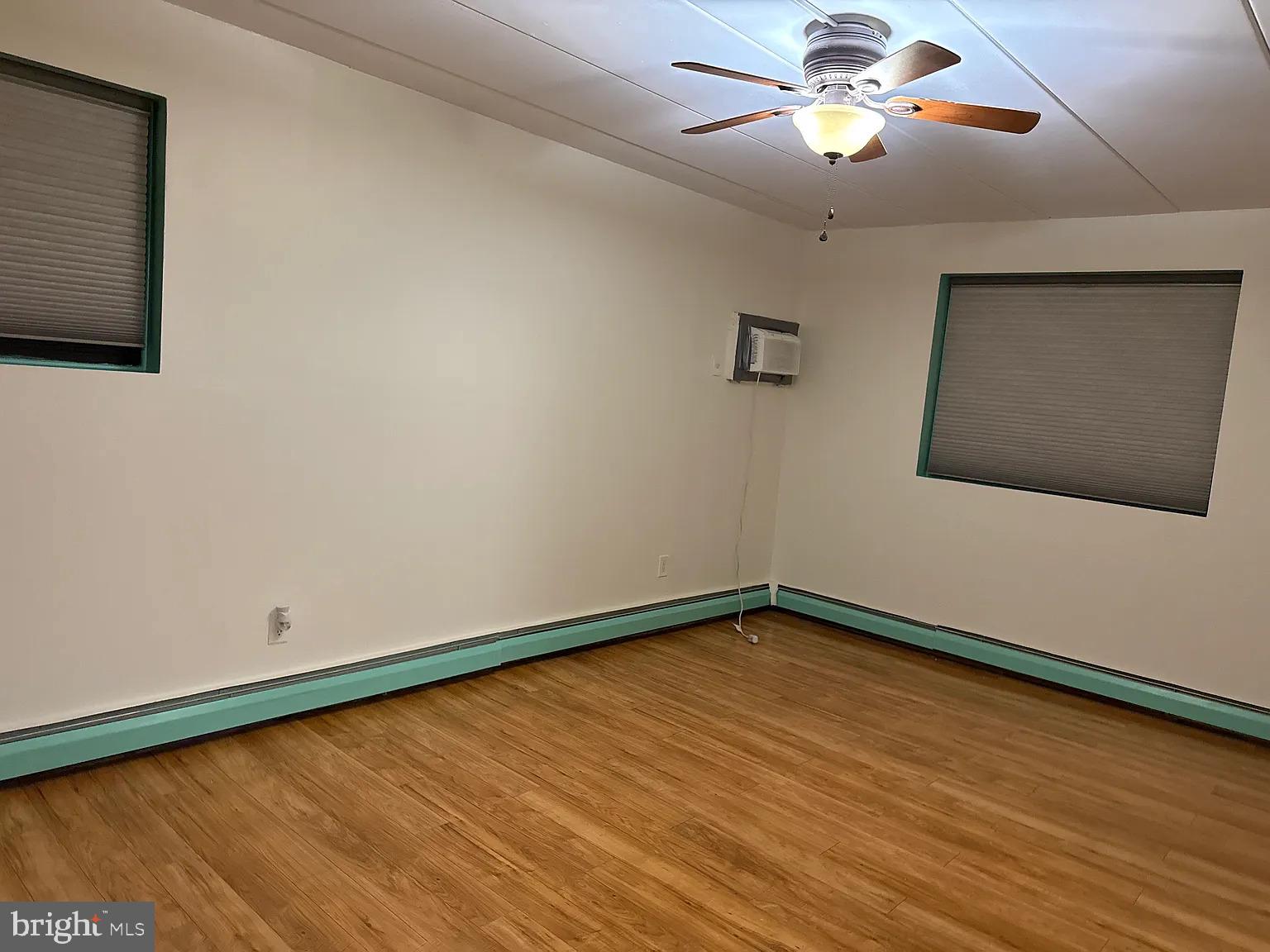 1575 West Street Road, Unit 812 Warminster, PA 18974 - Photo 8 of 17 a view of an empty room with a ceiling fan and wooden floor