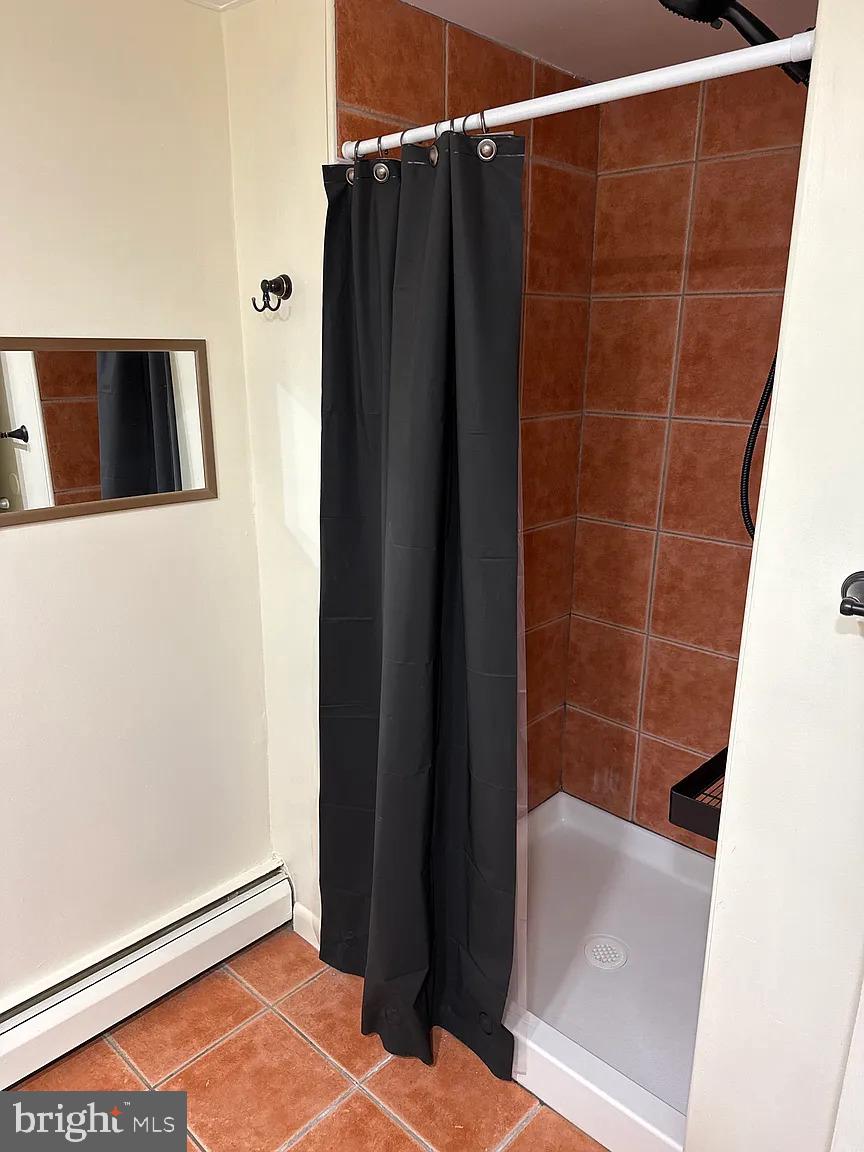 1575 West Street Road, Unit 812 Warminster, PA 18974 - Photo 9 of 17 a bathroom with a shower and a wooden floor