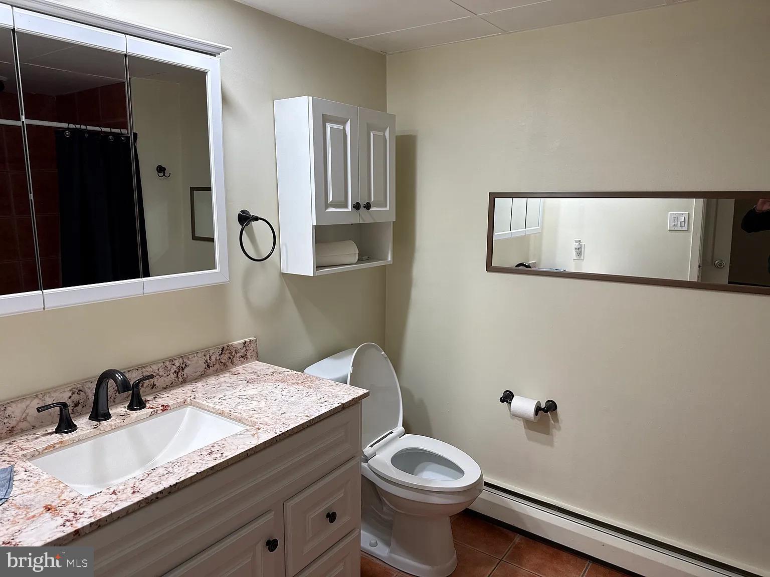 1575 West Street Road, Unit 812 Warminster, PA 18974 - Photo 10 of 17 a bathroom with a granite countertop sink and a mirror