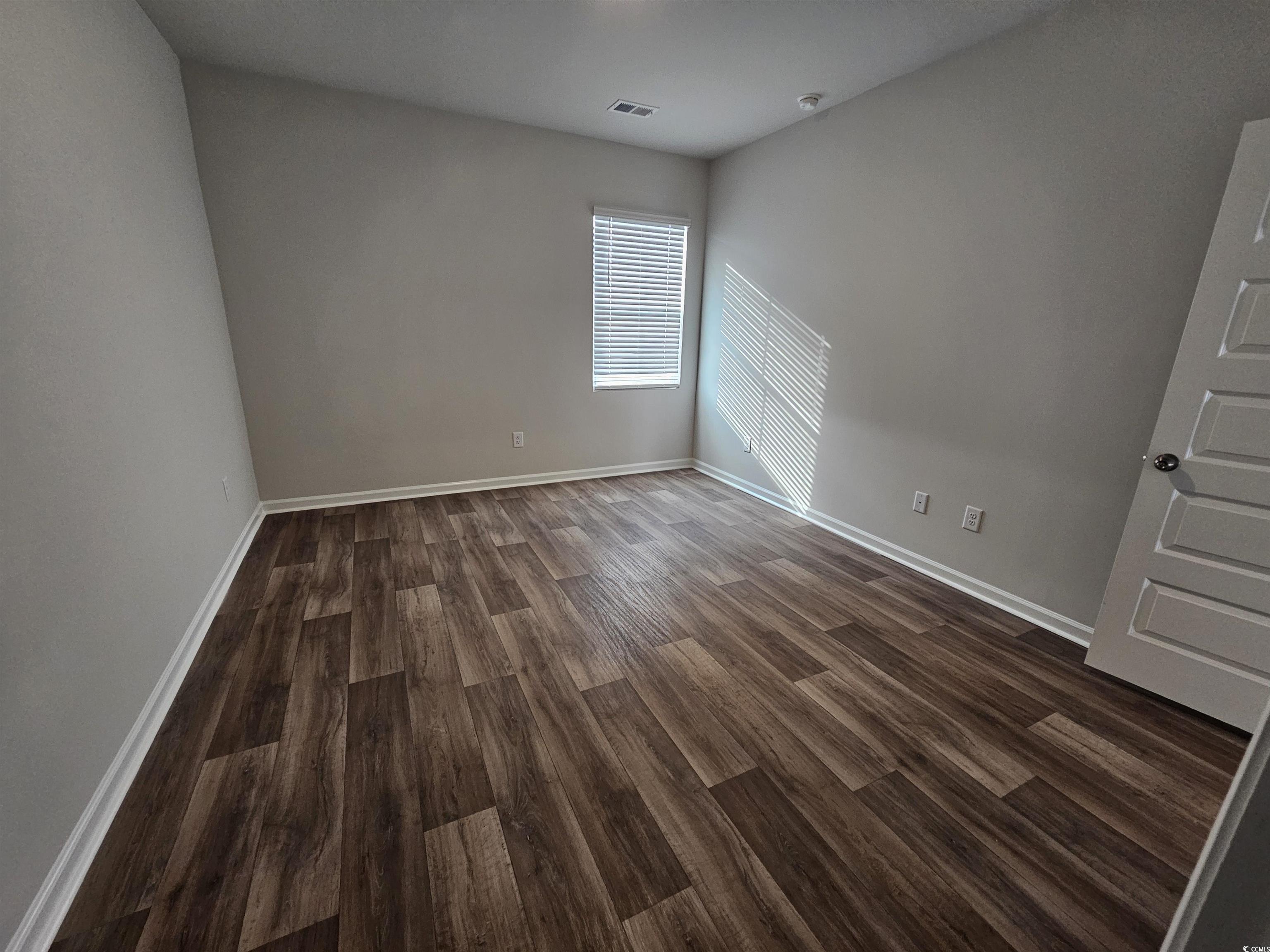 2096 Wild Indigo Circle Calabash, NC 28467 - Photo 11 of 29 Bedroom room with dark wood finished floors and baseboards