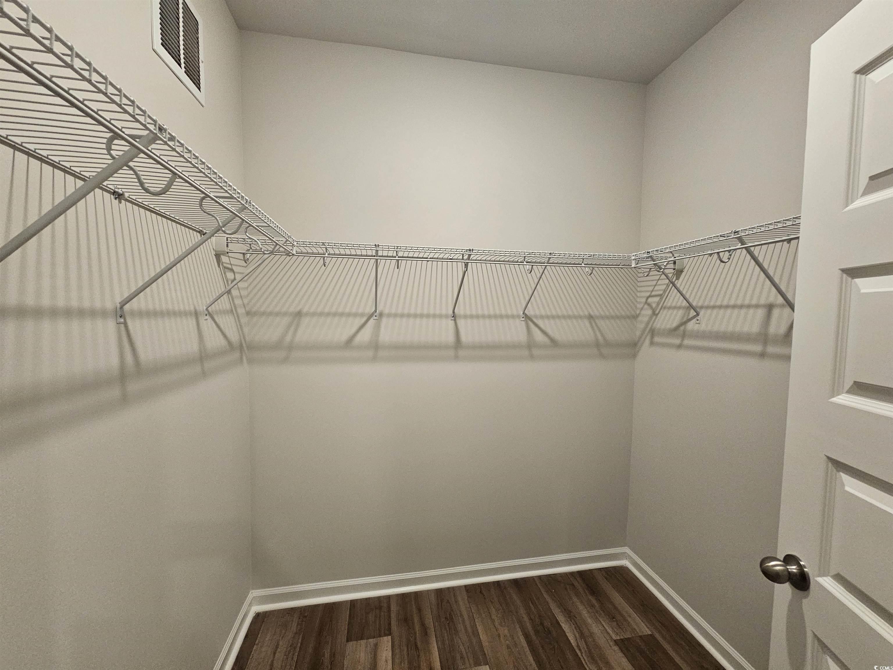 2096 Wild Indigo Circle Calabash, NC 28467 - Photo 12 of 29 Spacious closet featuring dark wood finished floors