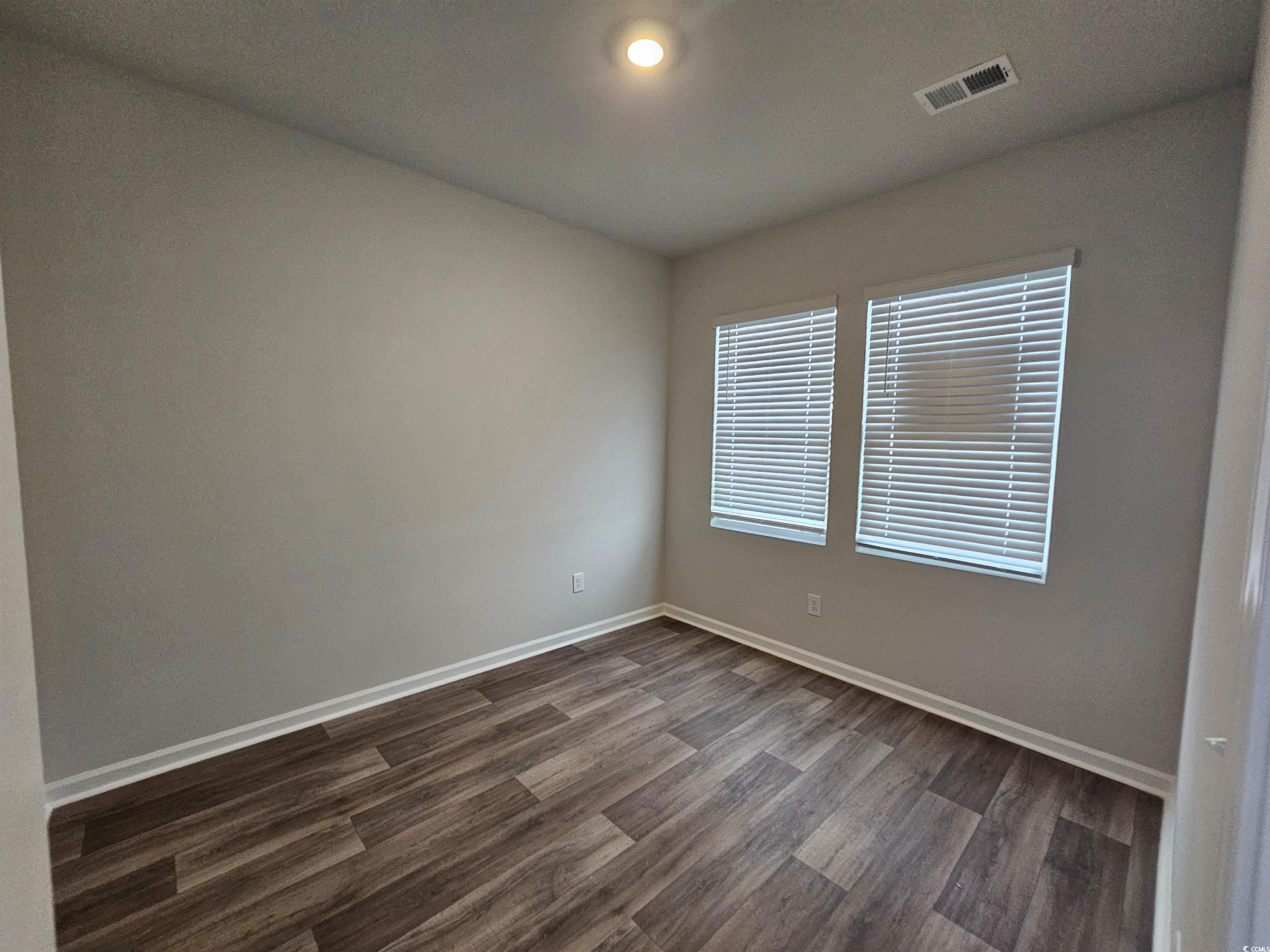 2096 Wild Indigo Circle Calabash, NC 28467 - Photo 16 of 29 Spare room with wood finished floors and baseboards