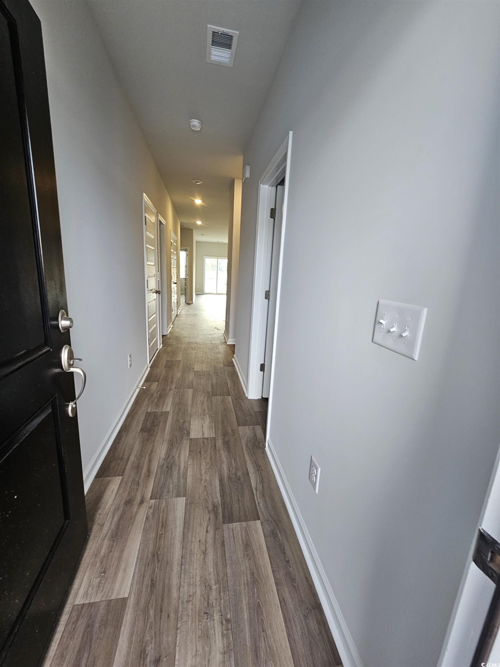 2096 Wild Indigo Circle Calabash, NC 28467 - Photo 2 of 29 Hallway with dark wood-style flooring and baseboards