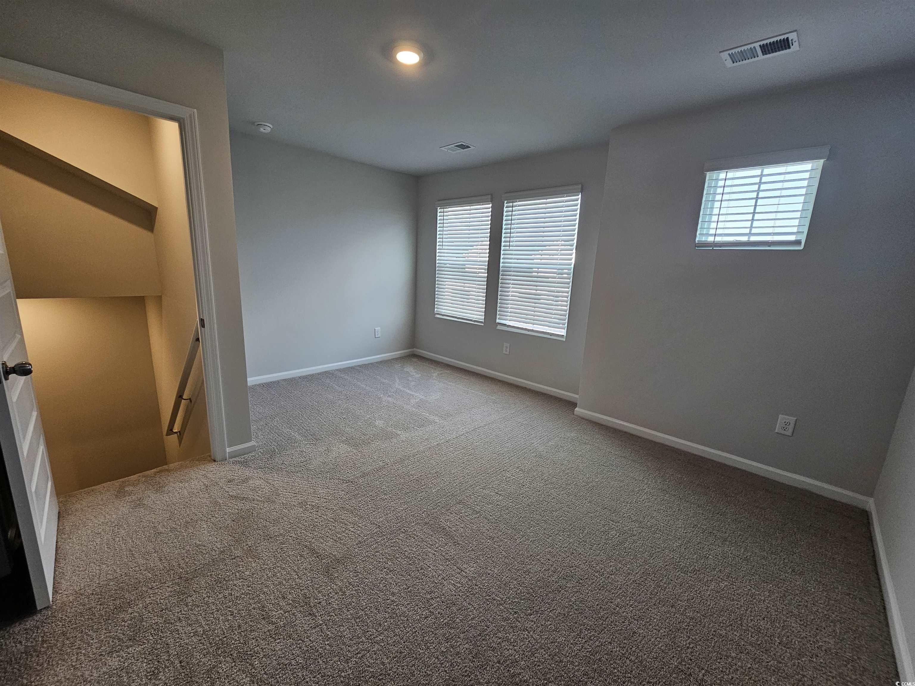 2096 Wild Indigo Circle Calabash, NC 28467 - Photo 21 of 29 Spare room featuring light carpet and baseboards