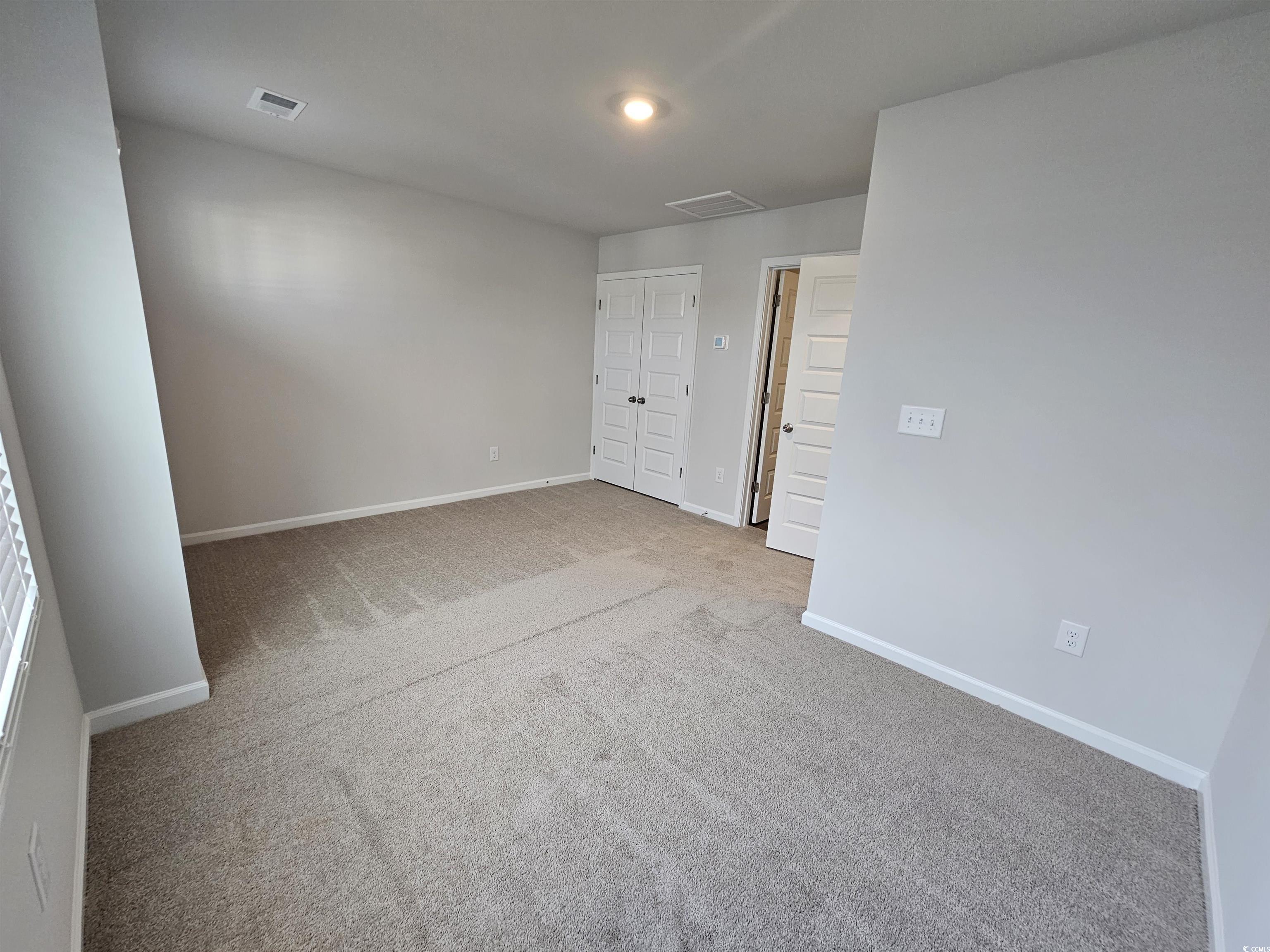 2096 Wild Indigo Circle Calabash, NC 28467 - Photo 22 of 29 Unfurnished bedroom with carpet flooring and a closet