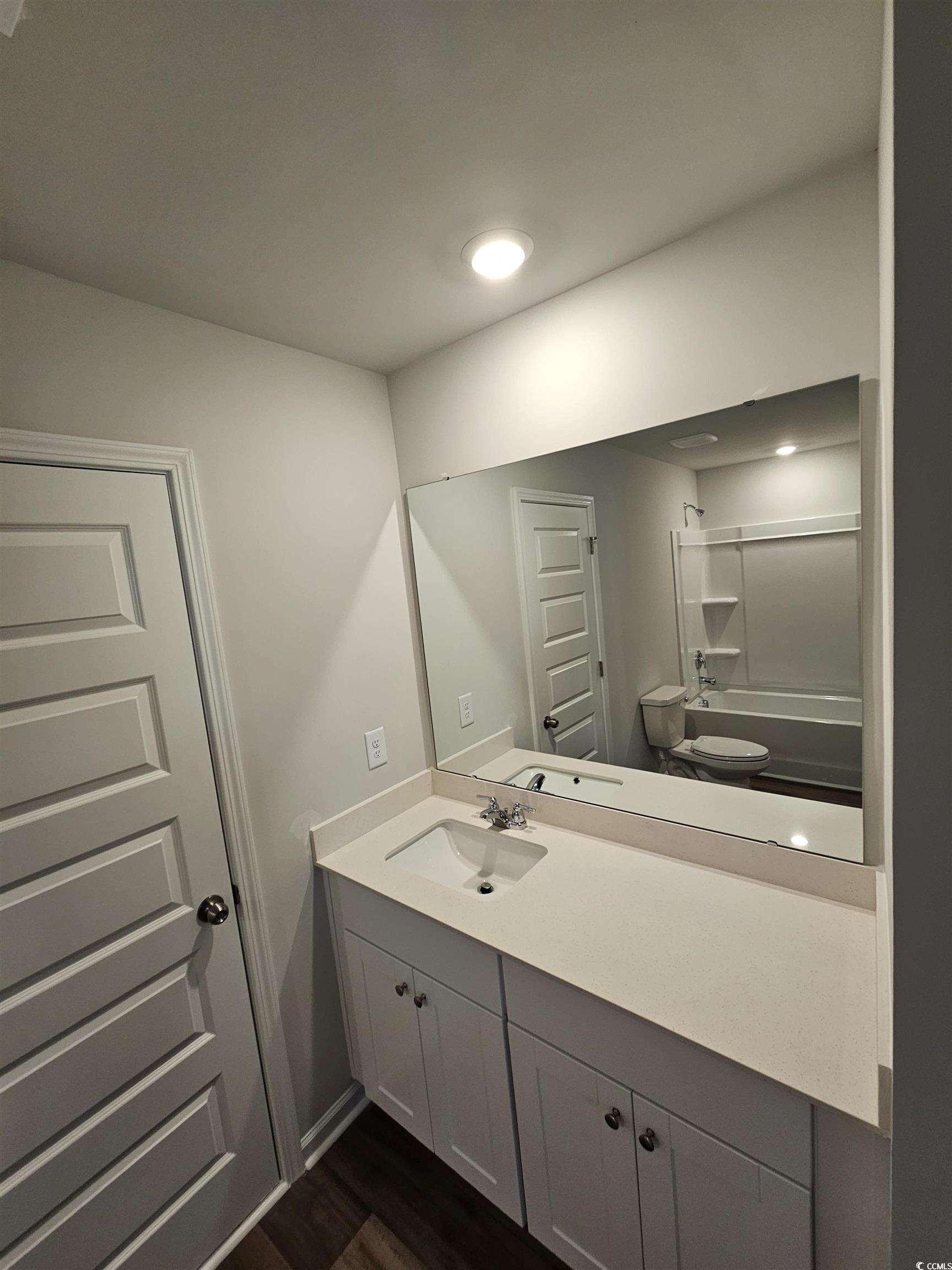 2096 Wild Indigo Circle Calabash, NC 28467 - Photo 23 of 29 Bathroom with vanity, shower / washtub combination, and dark wood-type flooring