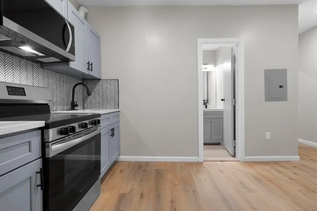 a kitchen with granite countertop a stove and a sink