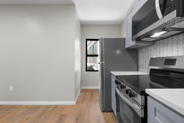 a kitchen with a stove and a refrigerator