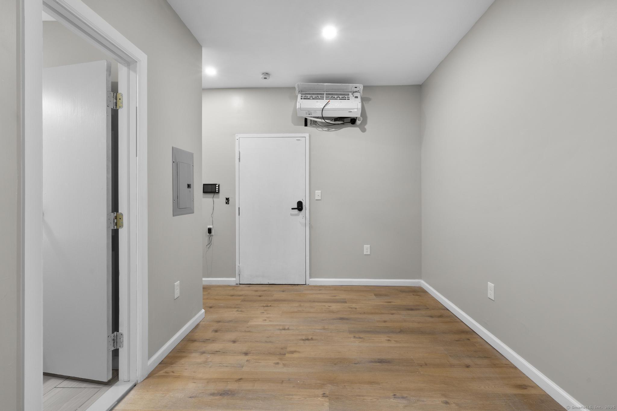 140 Grand Street, Unit 4C Waterbury, CT 06702 - Photo 10 of 14 a view of a hallway with wooden floor