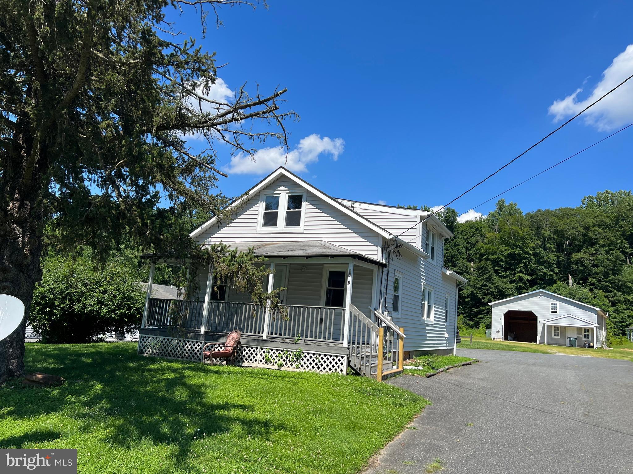 a front view of a house with a yard and porch