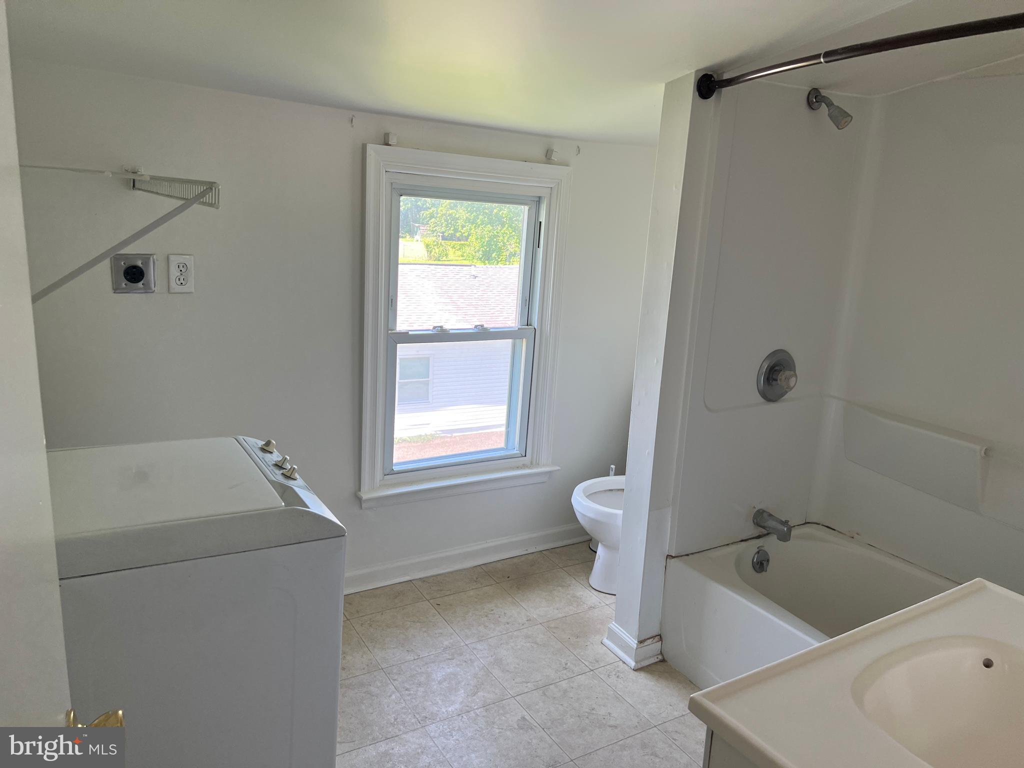 1636 Otts Chapel Road Newark, DE 19702 - Photo 13 of 24 a bathroom with a tub a sink and a window
