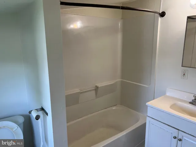 a bathroom with a shower and a sink