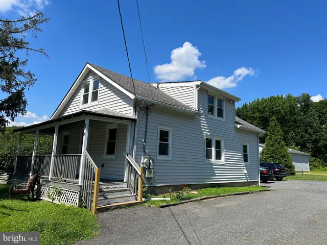 a view of a house with a yard and a garden