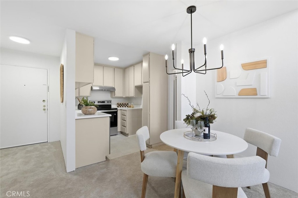 11645 Montana Avenue, Unit 321 Los Angeles, CA 90049 - Photo 16 of 41 a kitchen with refrigerator and chairs