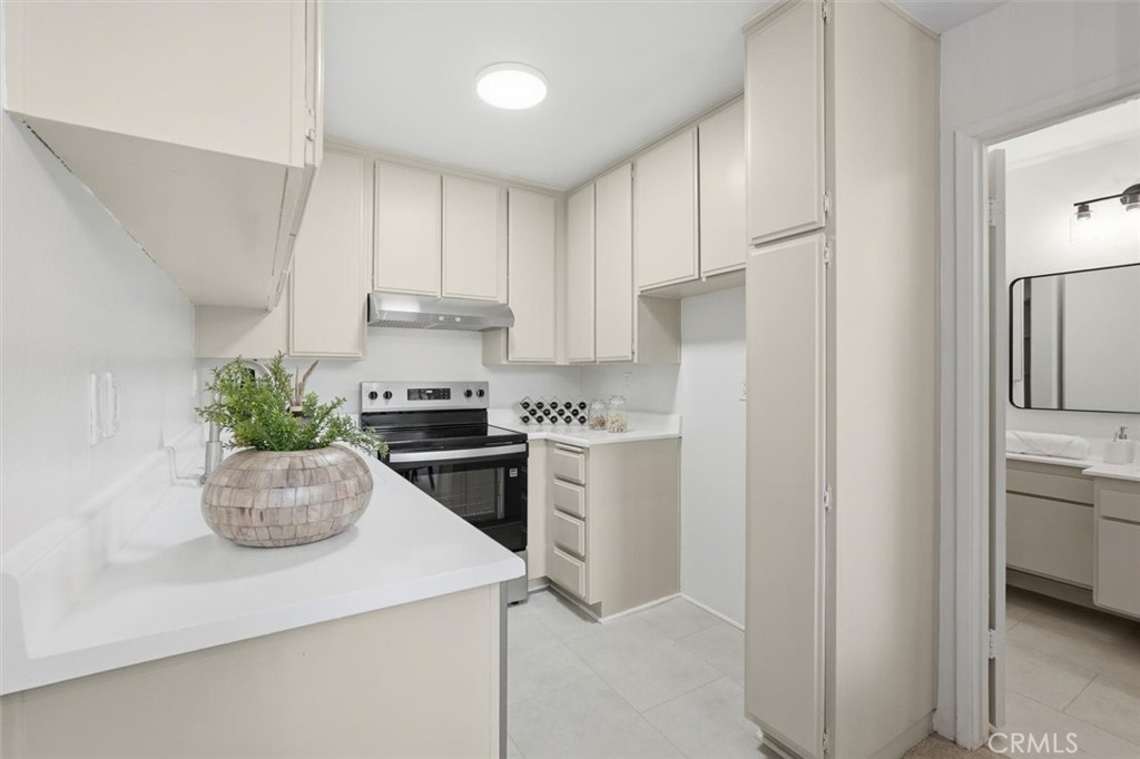 11645 Montana Avenue, Unit 321 Los Angeles, CA 90049 - Photo 9 of 41 a kitchen with a refrigerator and a white cabinets